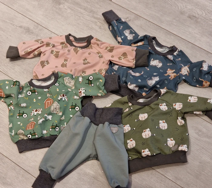 Präsentiert werden handgefertigte Babypullis und -hosen in diversen Farben, erhältlich in der Chiceria, solange Vorrat reicht